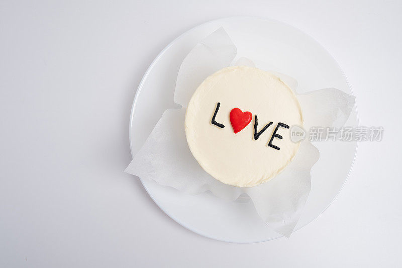 便当蛋糕上写着"爱与心"一个可爱的甜点礼物，适合任何场合给你爱的人。祝贺卡。爱情与糖果概念